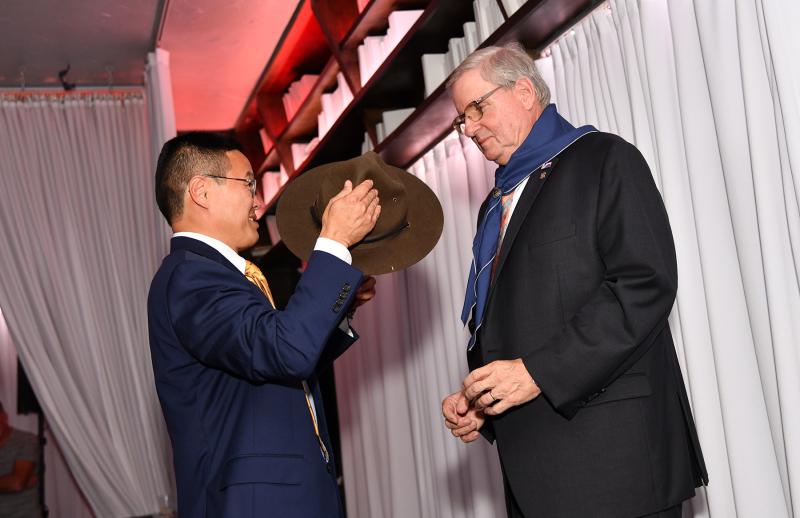Jack Riddle is presented with a scout hat by Robert Nakagawa, scout executive of the Del-Mar-Va Council.