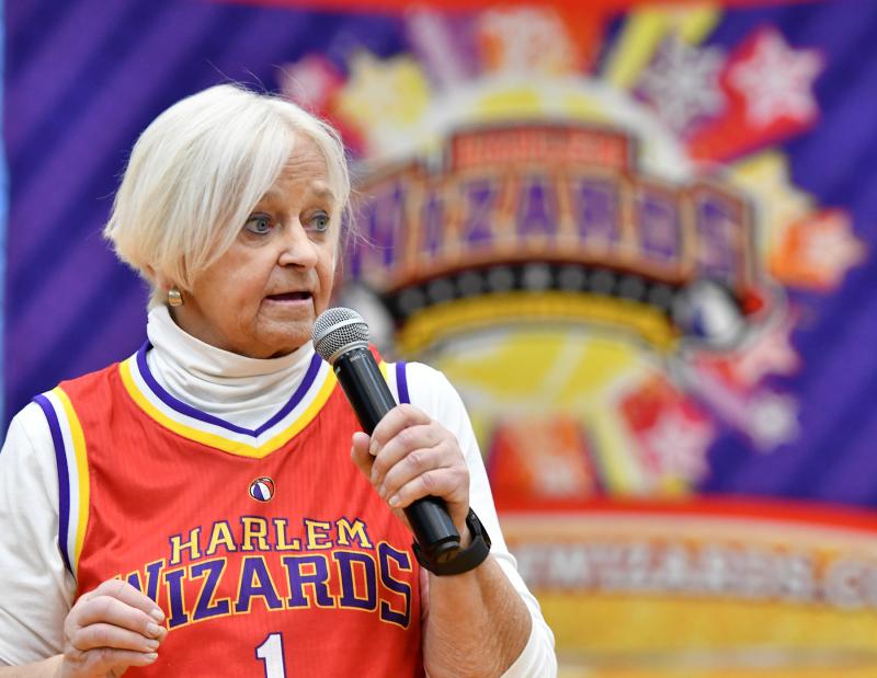 Pat Campbell-White, event co-chair, speaks to the crowd about the great things the Rotarians do with the funds raised at the Harlem Wizards show.