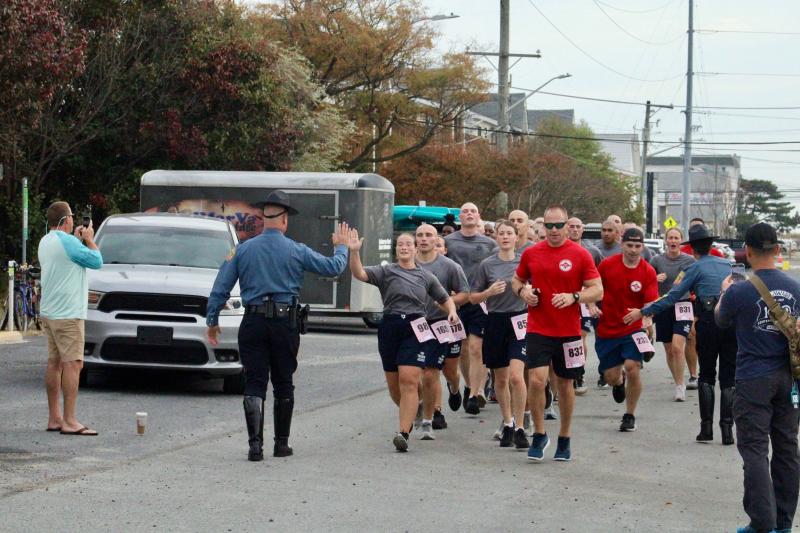 The Delaware State Police Training Academy and DSP team members began crossing the finish line as a unit at 32:11.4 and ended at 32:18.