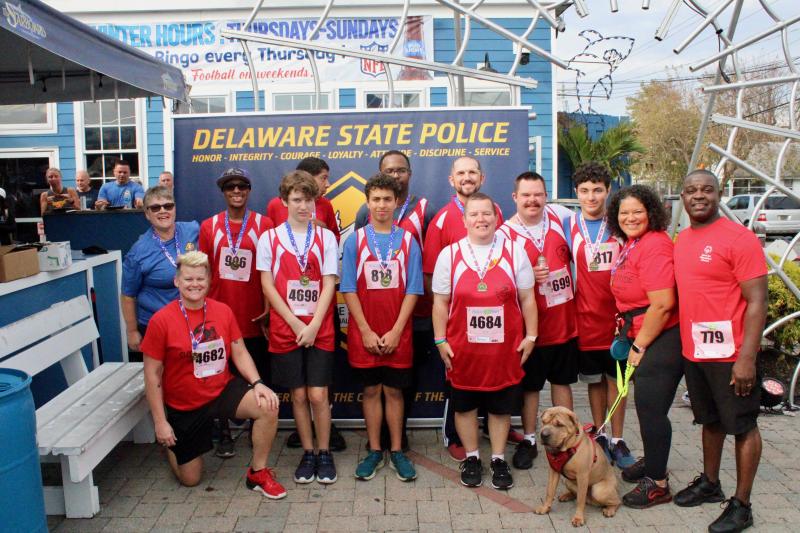 Delaware Special Olympics Sussex Riptide team members earned some drip for their efforts. Shown are in back (l-r) Young Athletes Director Louise Doe, Sasha Hudson, Dominic Beverly, Jeff Oliver, Connor Watson, Bruno Camarco, Donnel Bailey and Sussex County Area Director
Rob Bailey. In front are Wilma Holt, Cullen Oliver, Lucas Camarco, Donna Walton and King Titan, a shar pei.