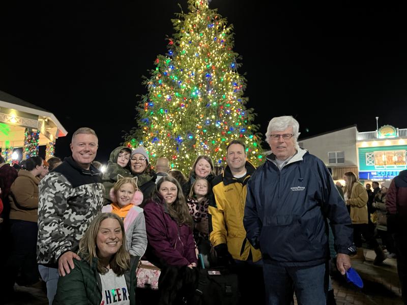 The Meier family poses for a photo in front of the Rehoboth Beach tree. Lynda Meier, kneeling on the left, said her family was there for the holiday from North Carolina.
