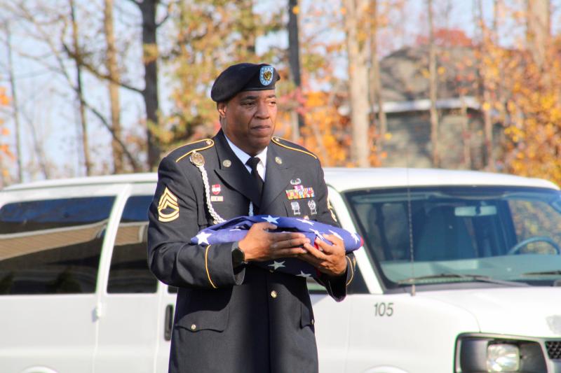 Sgt. First Class Richard Hurt, a Cape Henlopen JROTC instructor, walks the folded flag to the flag pole during the ceremony.