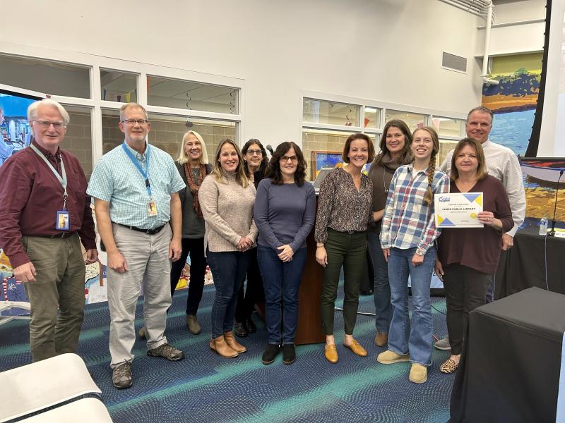 The Cape Henlopen school board recognized the Lewes Public Library as a community champion. Gathered at the Nov. 16 school board meeting are (l-r) Sussex Consortium job coaches Doug Gardner, David Wimmer and Stacey Maloney, LPL Director Jill DiPaolo, Sussex Consortium job coaches Julie Berheimer and Sue Murphy, board President Alison Myers, LPL Children’s Librarian & Program Coordinator Jennifer Noonan, Sussex Consortium student Ellie Nauman, LPL Volunteer Coordinator Tracy Dietz and Superintendent Bob Fulton. ELLEN DRISCOLL PHOTO