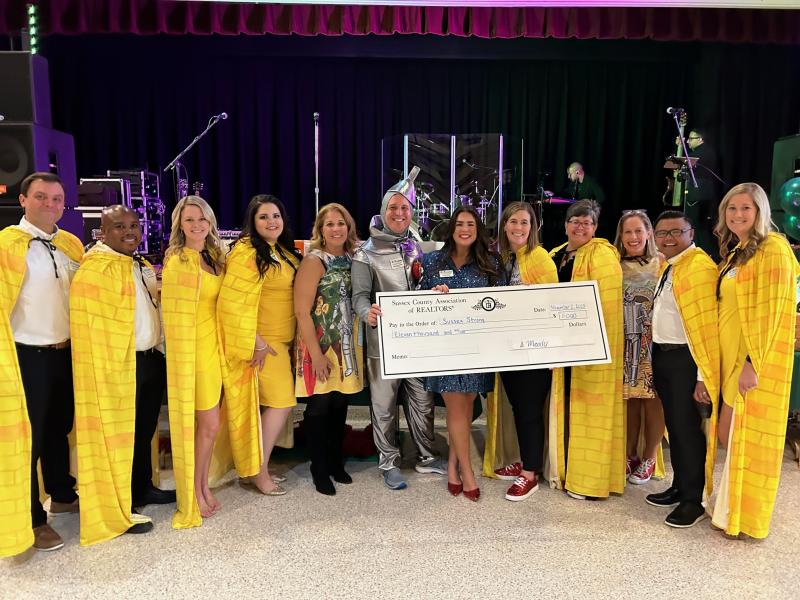 The Sussex County Association of Realtors board dressed as the yellow brick road from the Wizard of Oz at the Sussex Strong event Nov. 2 in Rehoboth Beach. Presenting an $11,000 check to Sussex Strong are (l-r) Tom Carney, Sterling Townsend, Jamie Coleman, Kacie Sharadan, Josette Castiglione, Mike Kennedy, Cecilia Waple, Stephanie Moody, Jenn Barrows, Brigit Taylor, Joe Gensoli and Jessica Harrison. RYAN MAVITY PHOTOS