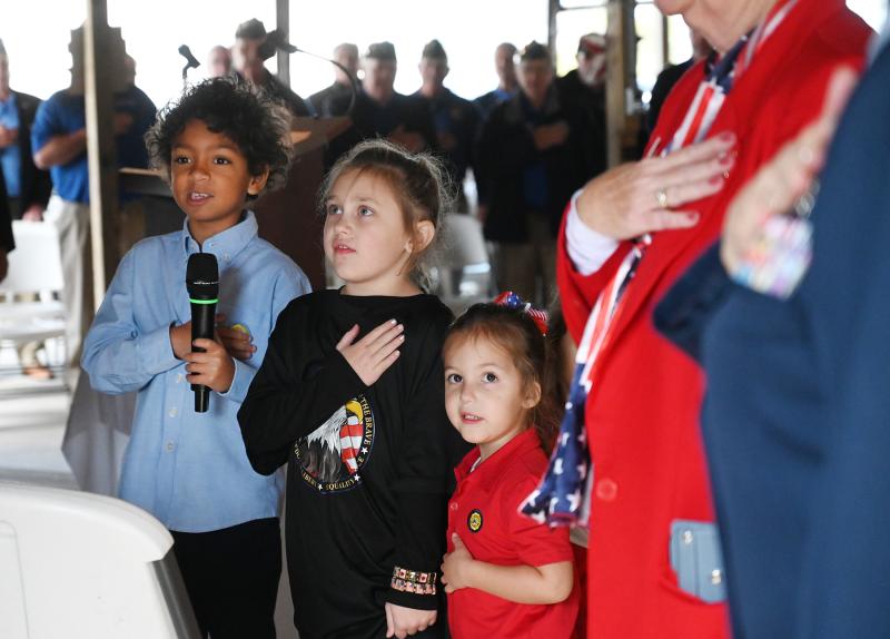 The youngest attendees say the Pledge of Allegiance at the Veterans Day ceremony. Shown are (l-r) Ethan Foos, Lily Armstrong and Eva Taurozzi.