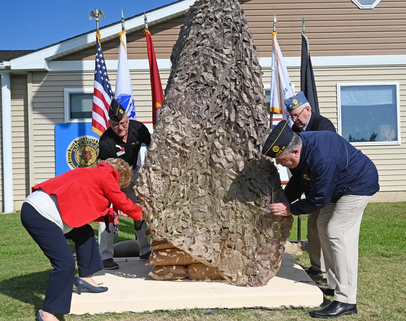 Unveiling the new veterans monument are (l-r) Auxiliary President Kellie Bergen, Retired First Sgt. Michael Bellerose, Commander Steven Missimer and Sons of the American Legion Squadron Commander Doug Spelman.