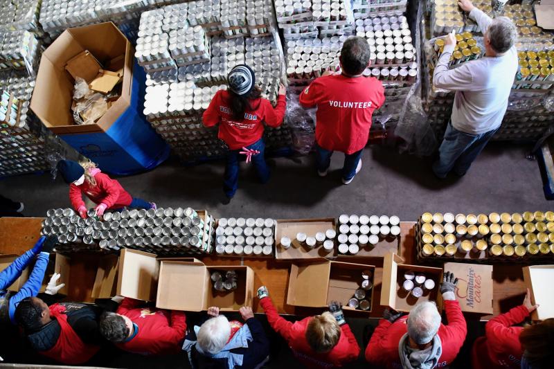 Seen from above, volunteers on the assembly line each have a specific assignment during the packing process.