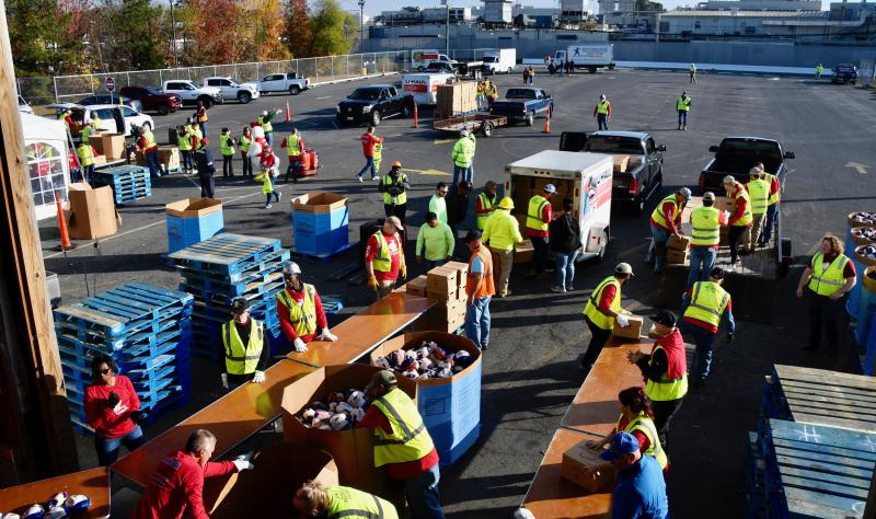 The Mountaire Selbyville plant parking lot is a beehive of activity as two assembly lines keep boxes coming to be loaded into vehicles.