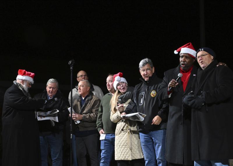 Singing are (l-r) Kevin Short; John Rieley, Sussex County Council; Michael Vincent, Sussex County Council; Douglas Hudson, Sussex County Council; Norman Jones, Clerk of the Peace; Colleen Davis, state treasurer; Thomas Bauer, Delmar mayor; Greg Fuller, Sussex County Register of Wills; and Bill West, Georgetown mayor.