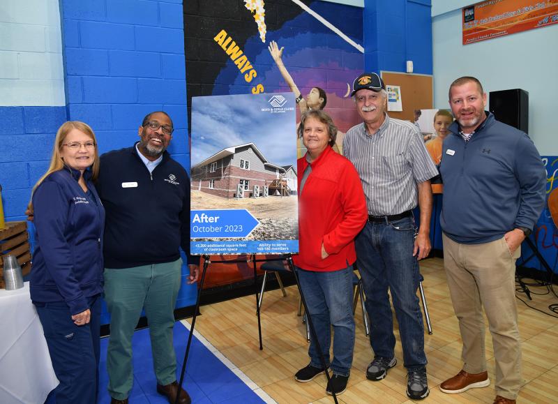 Posing with the after picture of the new building are (l-r) Bonnie Rogers, John Tucker, Carol Miller, Pastor Allan Miller and Chris Couch.