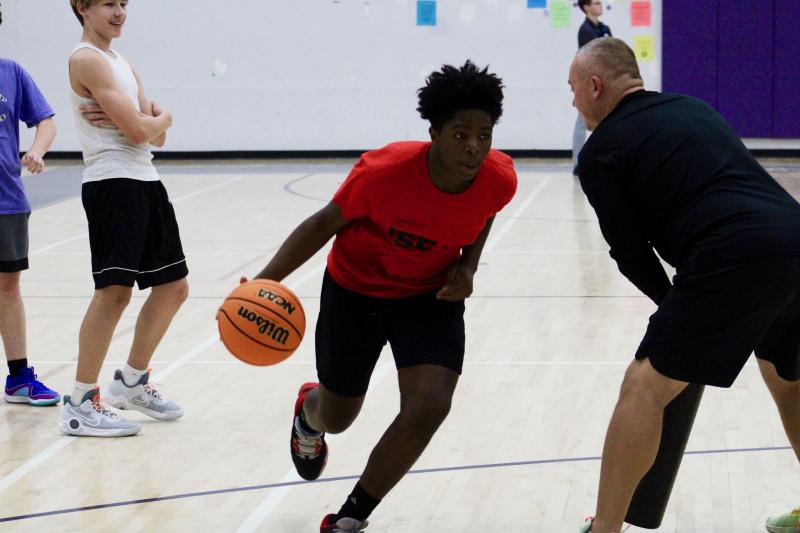 Seahawks freshman Sebastien Paul makes his way past coach Brad LeinBach who is preparing the young man for varsity physicality.