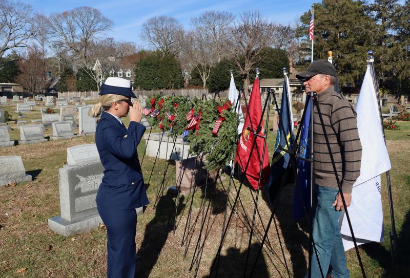 Petty Officer Second Class Sara Pounder salutes after placing a wreath in honor of the men and women of the U.S. Coast Guard.