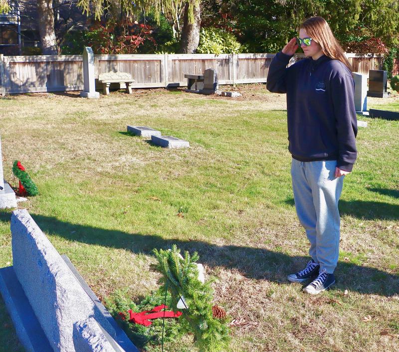 Madeline Sarver salutes after placing a wreath on her great grandfather’s grave. Sarver attends Radford University and will soon be commissioned a second lieutenant in the U.S. Army.