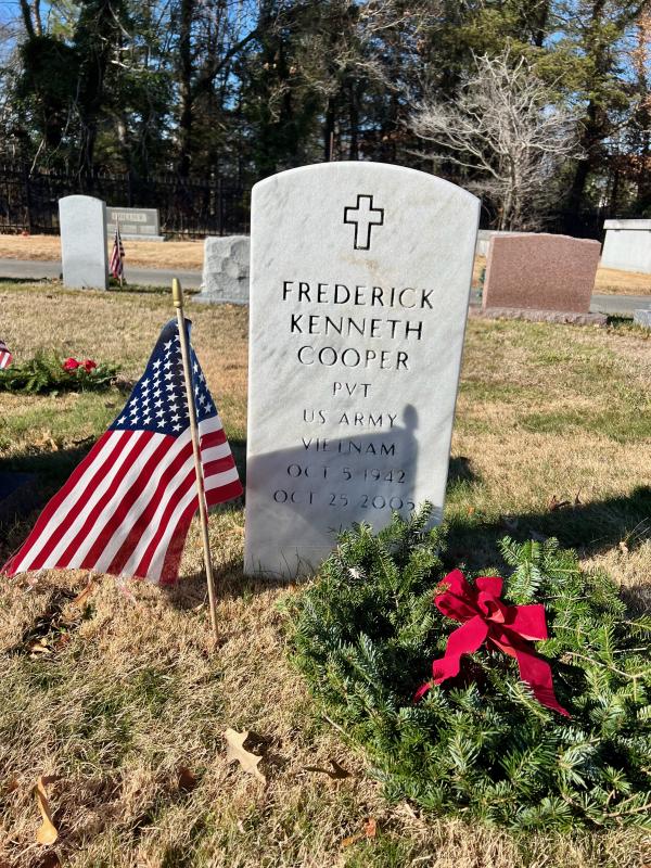 An American flag and wreath mark the grave of Army Private Frederick Kenneth Cooper.