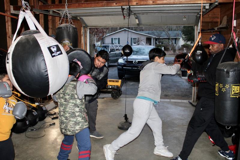 For now, USA Boxing coach Larry Woodall, right, is training in a makeshift gym, but the former Central Pennsylvania Boxing Champion is hoping to find a space that will allow more spots on the team to open up. Shown are (l-r) are Gerad Perez, Ozil Perez-Lopez, Jourdy Perez-Lopez and Woodall. AARON MUSHRUSH PHOTOS