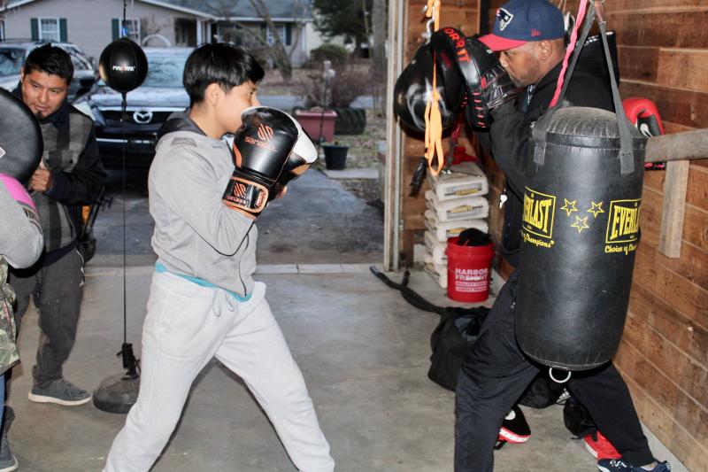 USA Boxing coach Larry Woodall, right, graduated from Cape High in 1995 and is hoping to give back to his home community by teaching a sport he excelled at. He is shown working with Jourdy Perez-Lopez.