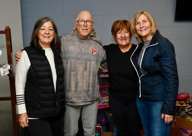 Toys for Tots volunteers (l-r) Terry O’Neill, Wally Gleason, Pam Alexander and Shelly Eden pause for a second during a busy day of sorting and storing toys. They call themselves the A Team.