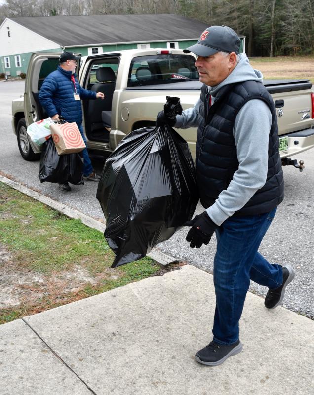 Volunteers Tom DeFazio, right, and Paul Wilson unload a donation of toys to support the annual holiday campaign.