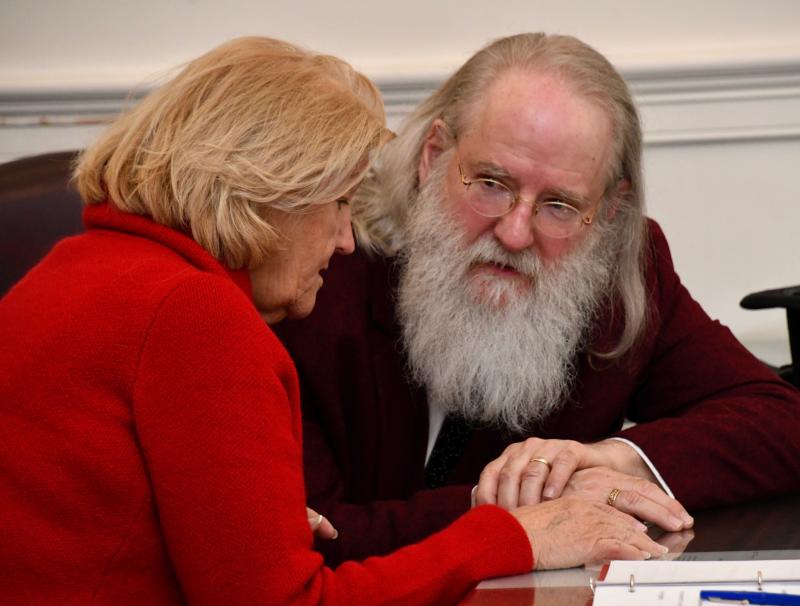Defense attorney Jane Brady confers with her client, Kris Kringle, as the court proceedings get underway.
