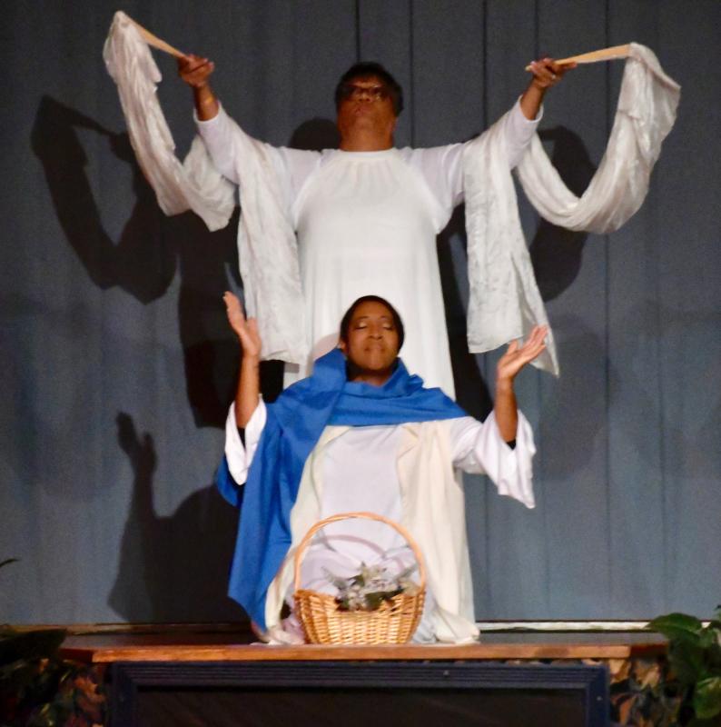 Mary, portrayed by Rhonda Brown, is visited by an angel, portrayed by Chantea Harmon, during the Nativity presentation.