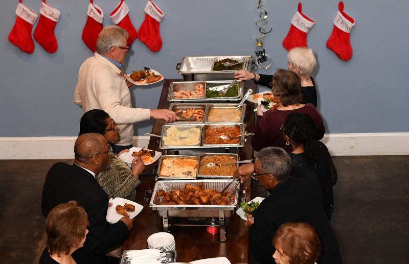 Final-night patrons enjoy a buffet of salmon, fried chicken, catfish, pork ragu, steamed shrimp, black eyed peas and rice, collard greens, green beans and mashed potatoes.