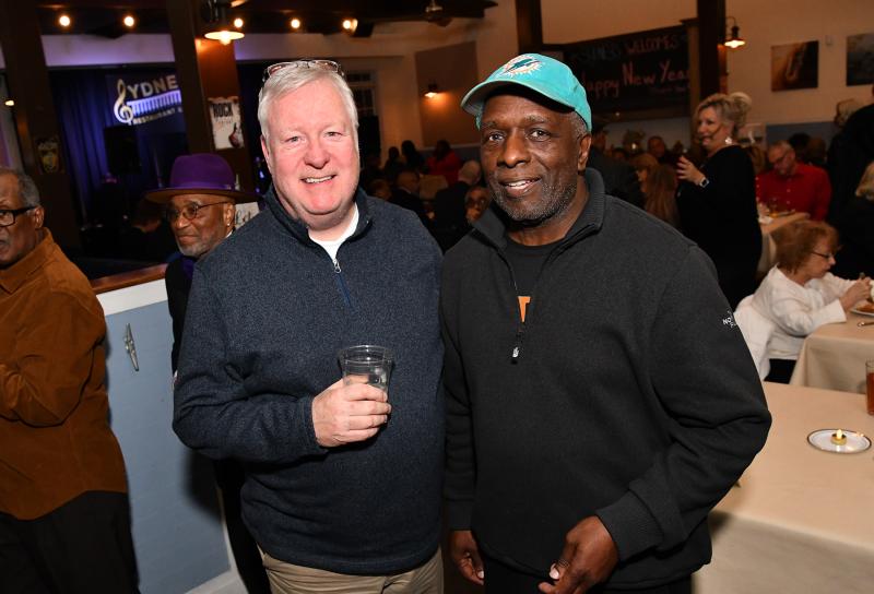 Matt Lafferty, a musician who has appeared many times at Sydney’s, gets a picture with co-owner Elton Lewis.