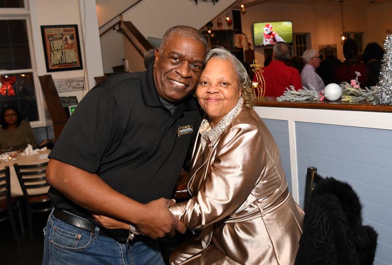 Sydney’s co-owner Anthony Lewis gets a farewell hug from patron Daphney Walker.