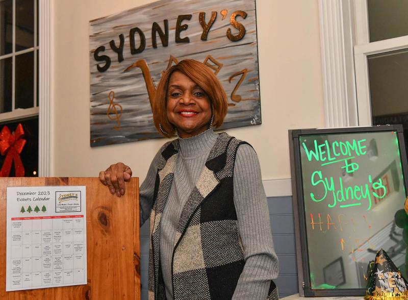 Hostess Pat Leggins shows her pleasant smile as she welcomes patrons for the final evening of the popular restaurant.