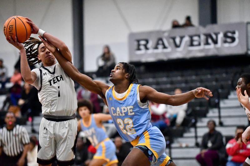 Cape freshman Oz Daisey just misses grabbing the offensive board as Sussex Tech junior Kyle Thompson secures the ball.
