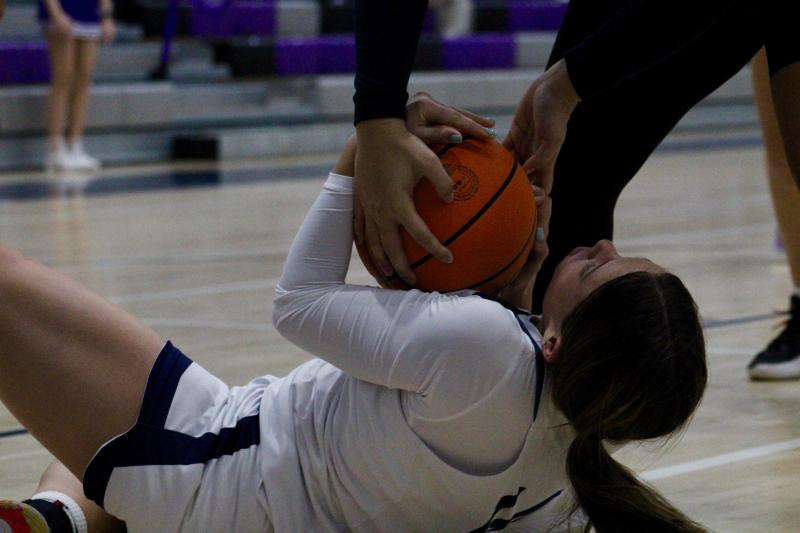 Seahawks freshman Grayce Glover fights hard for the ball as coach Rayona Benson calls a timeout to preserve possession.