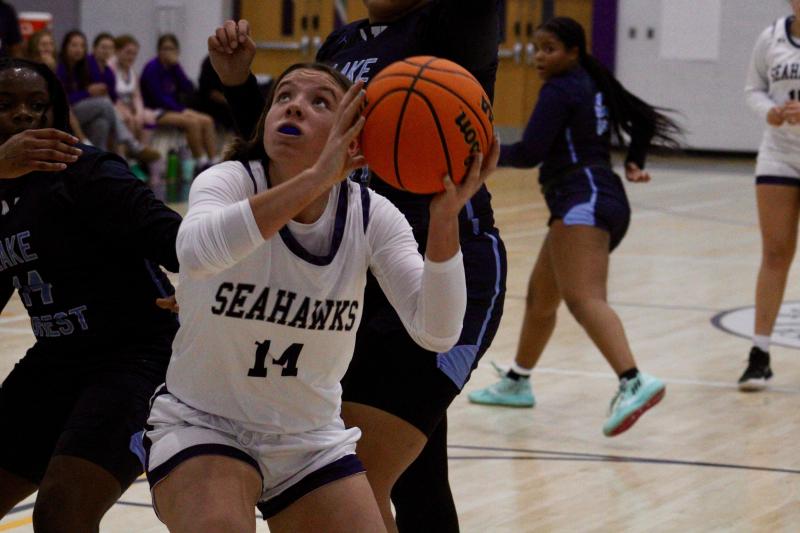 Seahawks freshman Grayce Glover secures an offensive rebound in the second quarter against Lake Forest.