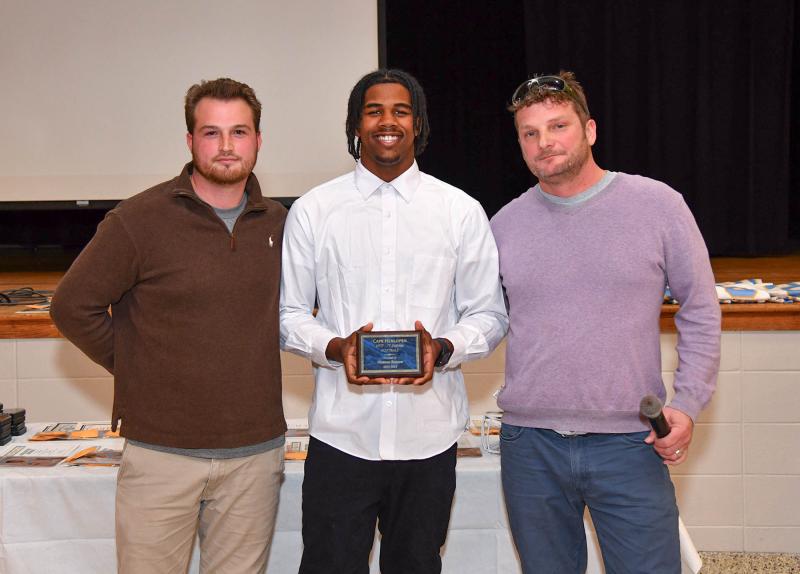 Freshman Ozmeer Daisey, center, receives the JV Most Valuable Defensive Player award from coaches Ben Ashby, left, and Jack Frederick.