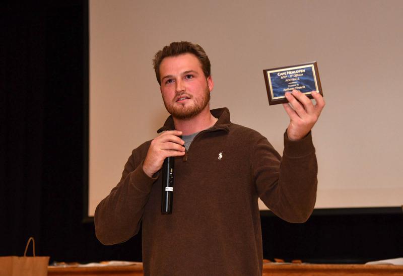 JV coach Ben Ashby holds the plaque for JV Most Valuable Offensive Player Anthony Francis who was not present.