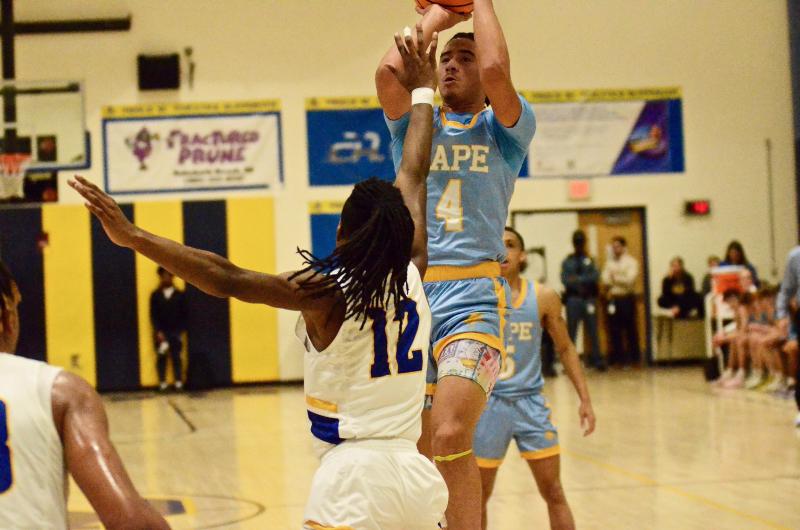 Even with Golden Knights junior Raymond Pierre’s hand in his face, Vikings freshman Jameson Tingle hits a jumper.