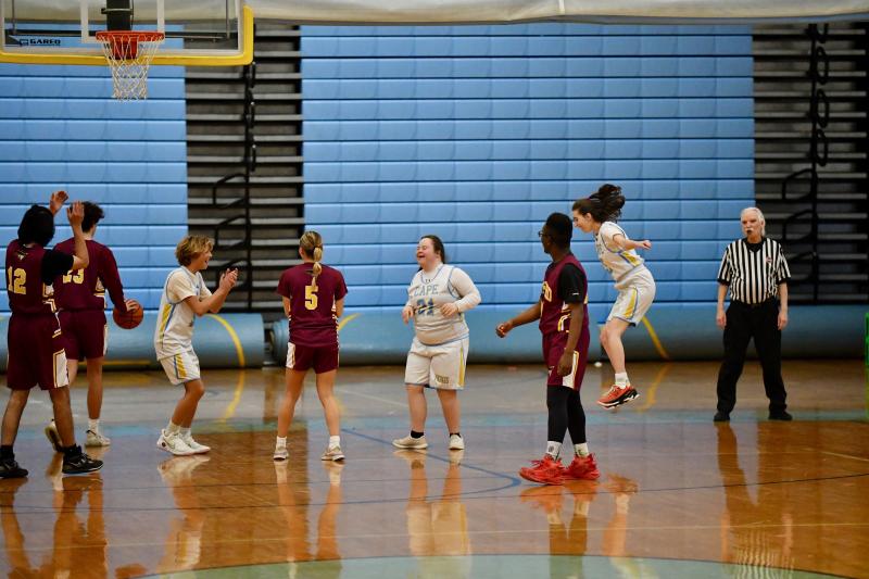 After Cape junior Sara Davis, middle, makes a bucket, Cooper Forcucci, left, and Peyton Lamson-Reich celebrate.