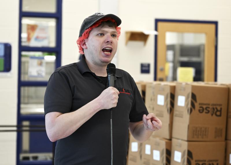 Ryan Ehmts, regional manager for Rise Against Hunger’s Philadelphia office, speaks with the crowd and delivers instructions for completing the food packs.