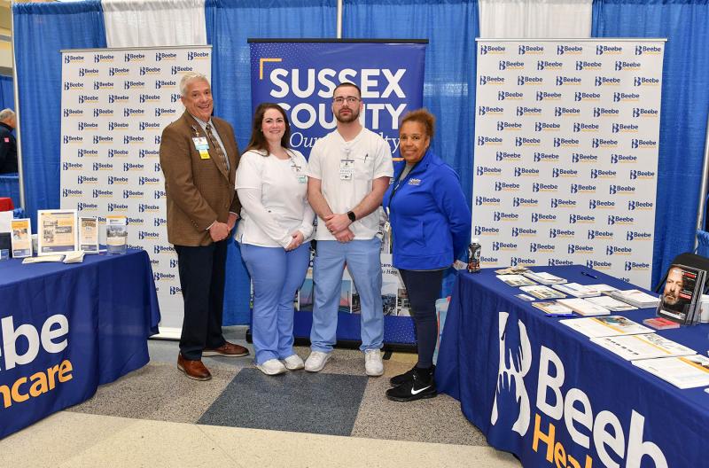 Working at the Beebe Healthcare information booth are David Szumski, Mary Helen Waltjer, Francesco Malone and Elizabeth Campbell.