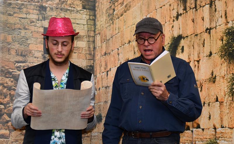 Reading from the Megillah are Sholom Shur, a yeshiva student from Baltimore, and Dr. Abraham Scheer.