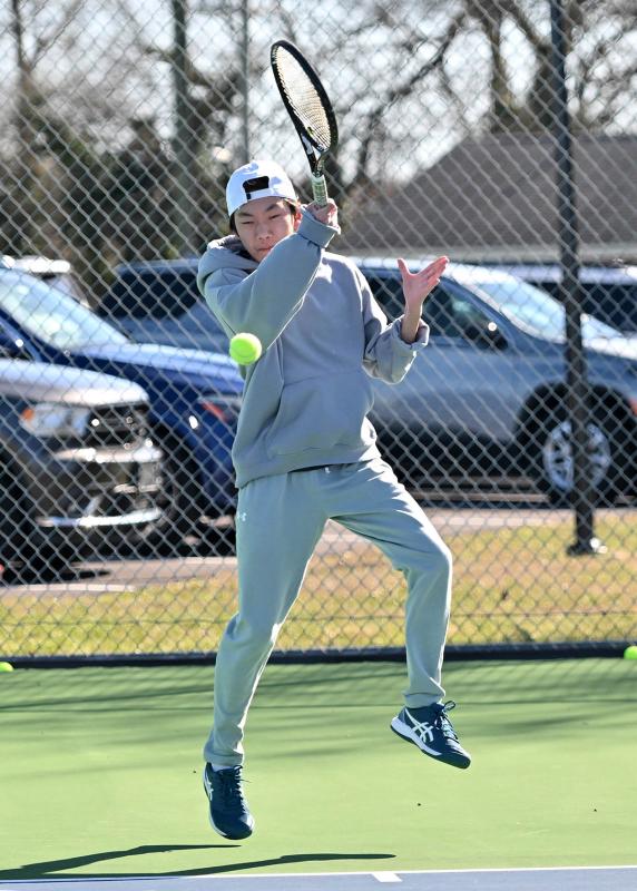 Sophomore Nathaniel Hoang cranks a forehand in a recent practice. He will compete for a singles spot in the lineup.