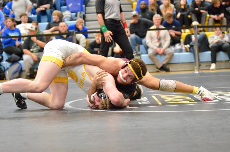 Milford senior Jordan Curry checks the clock as he controls Finn Hanna of Saint Mark’s to lock up third place in the 190-pound bracket.
