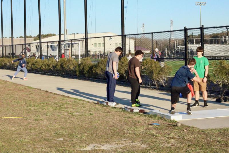 It’s one thing to pick up heavy things and put them down, but quite another to hurl them through the air. Shown practicing for shot and discus events are (l-r) Emma Mullen, Ryan Podrasky, Max Rial, Christian West and Evan Spanos.