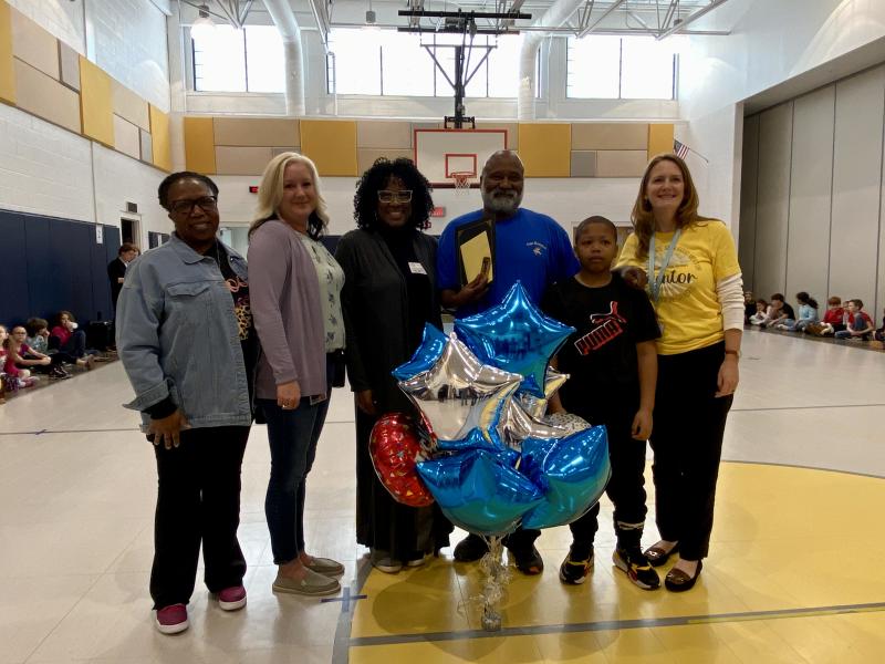 In January 2023, Michael Thomas was named the Creative Mentoring Mentor of the Month for the State of Delaware. Gathered at the surprise ceremony last year are (l-r) Love Creek Counselor Beonica Duffy, Love Creek Mentor Coordinator Stacy Moore, Creative Mentoring Director Tanny Dickerson, Thomas, student Armanti Wilson and Cape District Mentor Coordinator Kim Hoey Stevenson. ELLEN DRISCOLL PHOTO