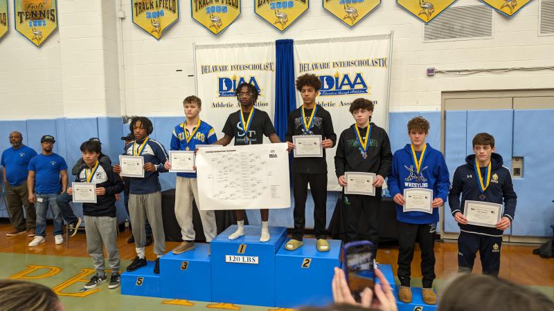 Sussex Central’s Malachi Stratton won his third straight wrestling state championship, this time at 120 pounds. Shown are (l-r) Kaeden Fleming, DeMarion Russ, Cole Moffett, Stratton, Anthony Andrews, Russell Lloyd, Brayden Kelley and Tyler Delcollo.