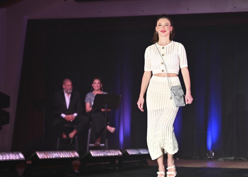 Kendal Wiley was cool in her white dress from Coral Cove. In the background are L. Drexel Davison and Maureen Eschbach, emcees for the evening.