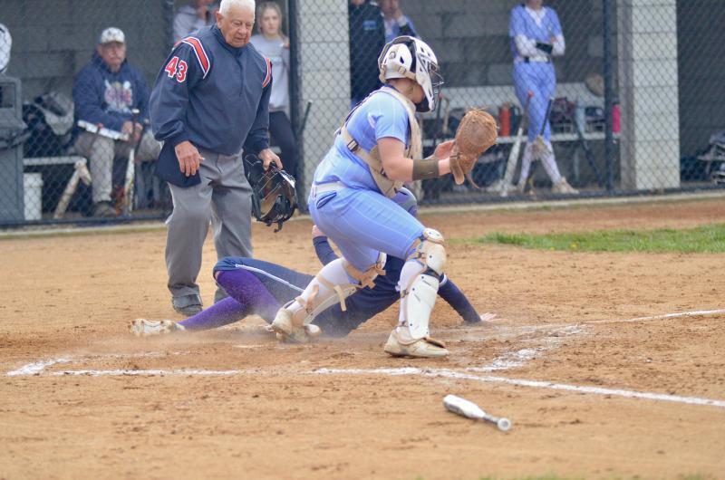 Sussex Academy centerfielder Ryan Lowe slides into home ahead of the throw to score the Seahawks' first run in the second inning.