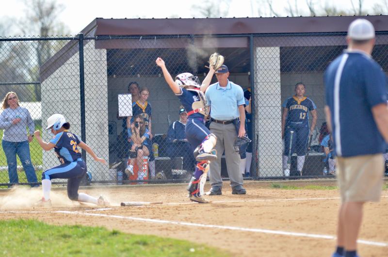 As Cape left fielder Natayla Roundtree slides safely into home, Seahawks catcher Delanie Monitzer makes an acrobatic grab.