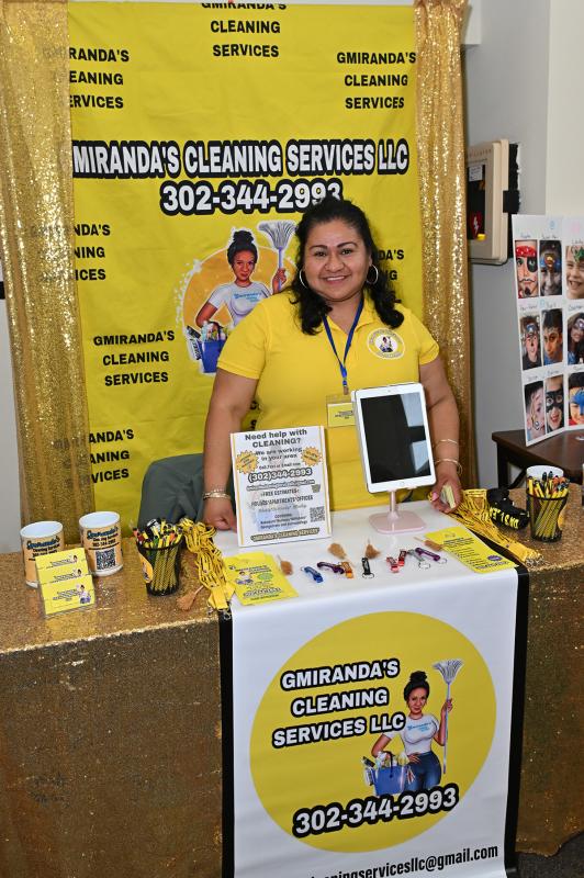 Gloria Miranda of Gmiranda’s Cleaning Service gives certificates worth 10% off her services at the event.
