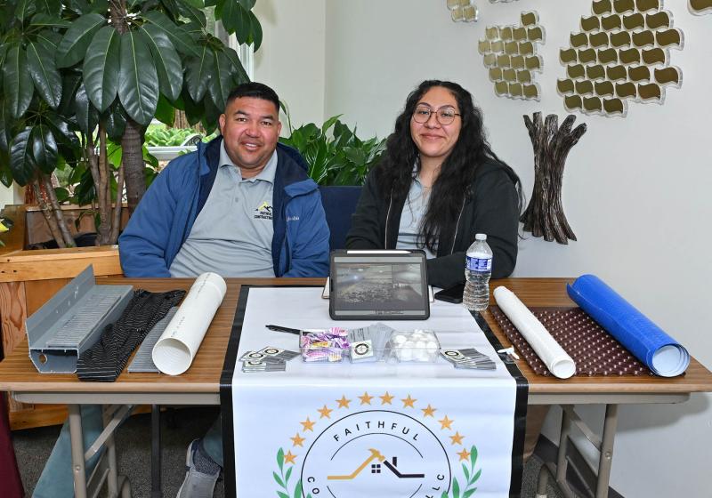 Martin Aguilar, left, and Jeydi Vasquez of Faithful Contracting offer information about their many services like crawl space encapsulation, roofing, landscaping and more.