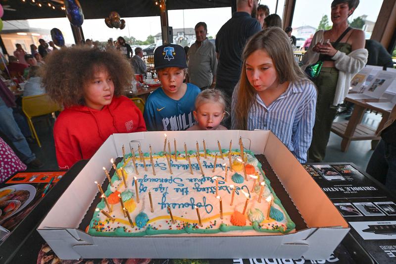 Blowing out the candles on Spoonie’s birthday cake are (l-r) Maya Davis, 9; and Ben, 7; Nora, 5; and Addie Bekeshka, 10.