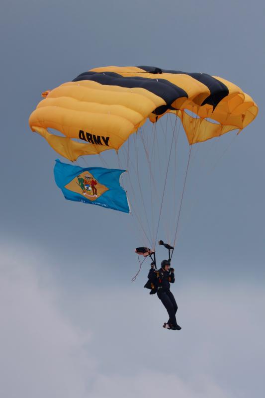 A member of the U.S. Army’s Golden Knights parachute team arriving with the Delaware state flag. A record crowd of 100,000 people attended May 19, according to the air show announcer.